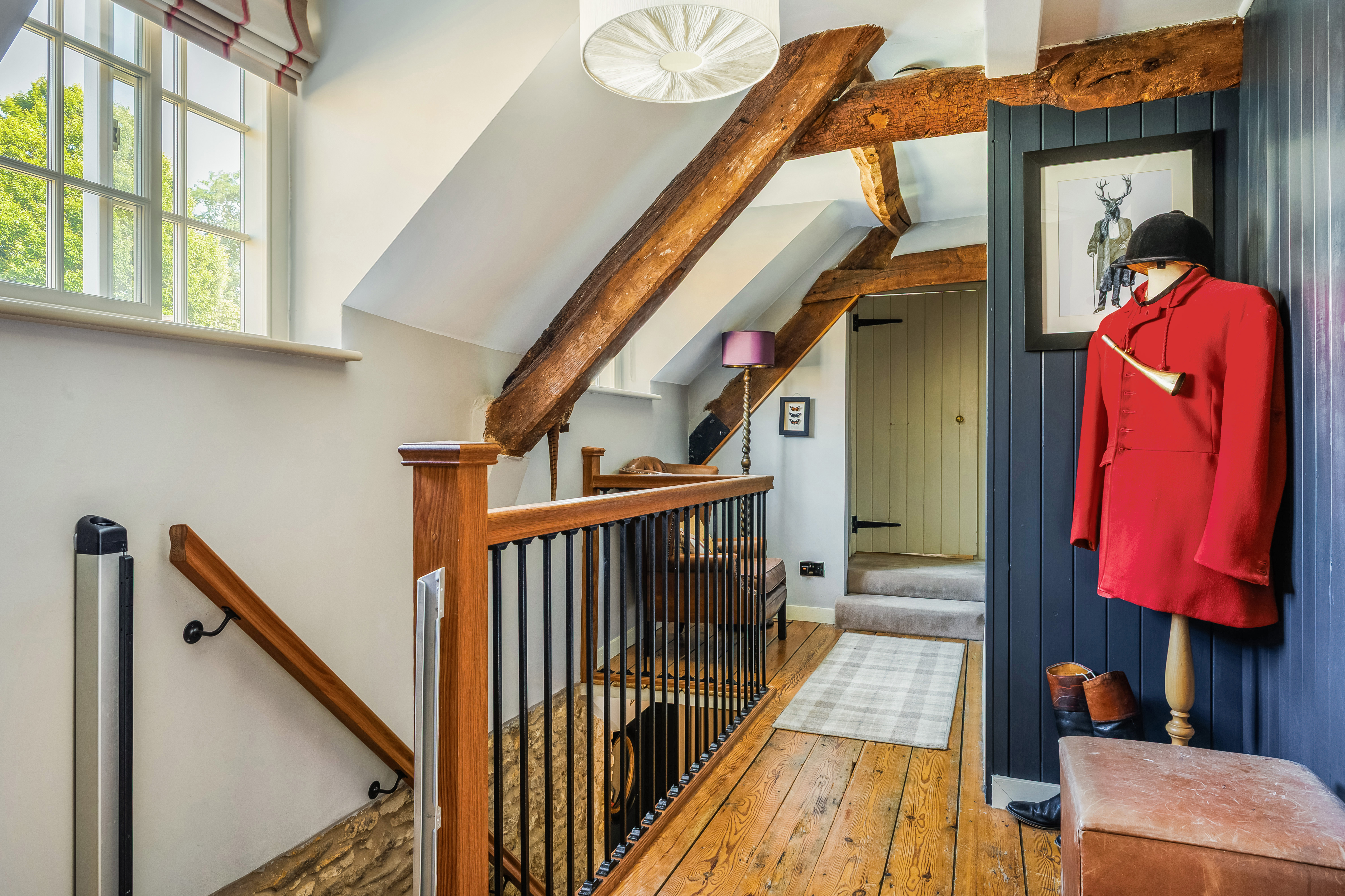 Oak-beamed landing with period features and character décor at Yew Tree Cottage Westow